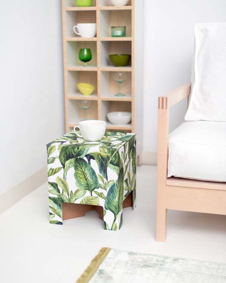 Green Leaves Chair. the Chair is adorned with large green leaves on a white background.