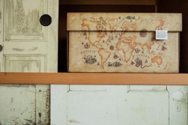 Storage box with an image of an old world map. The box has the color of old faded paper.