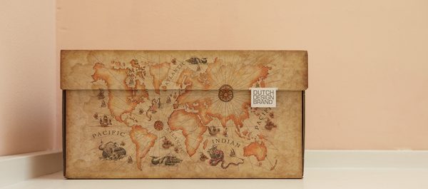 Storage box with an image of an old world map. The box has the color of old faded paper.