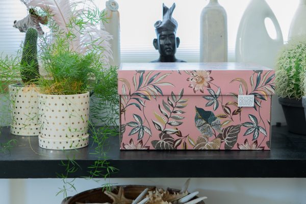 Floral Garden Storage Box is a pink box adorned with various colourful leaves and flowers.