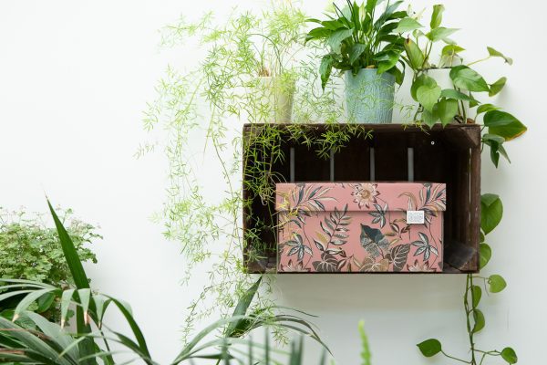 Floral Garden Storage Box is a pink box adorned with various colourful leaves and flowers.