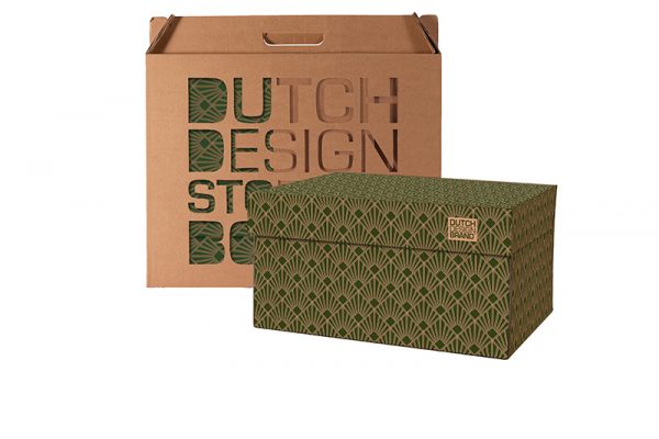 Storage Box Art Deco Green Velvet with the packaging in the background. The box is decorated with a 20s geometric Art Deco print in green and gold.