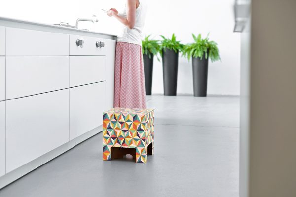 Back to the 60s Chair. The chair is decorated with several colourful geometric shapes.