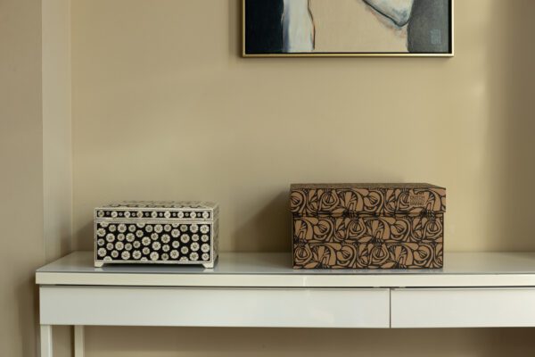 A storage box with a black organic root pattern printed on brown cardboard, labeled 'Dutch Design Brand.'